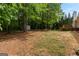 View of backyard with shed, firepit area, wooden deck, and mature trees offering plenty of shade at 372 River Point Dr, Mcdonough, GA 30252