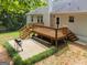 Backyard view showcasing the wooden deck, grill area, and lush green surroundings at 372 River Point Dr, Mcdonough, GA 30252