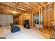 Partially finished basement with exposed framing and a cozy seating area, offering potential for additional living space at 372 River Point Dr, Mcdonough, GA 30252