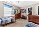 A bedroom featuring two beds with blue striped comforters, and carpeted floor at 372 River Point Dr, Mcdonough, GA 30252