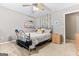 The carpeted bedroom features shelves, a ceiling fan, and neutral-colored walls at 372 River Point Dr, Mcdonough, GA 30252