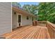 A spacious wooden deck is attached to this home, with access to the backyard and a door to the house at 372 River Point Dr, Mcdonough, GA 30252