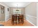 Bright dining room featuring a wood table with seating for six under a chandelier at 372 River Point Dr, Mcdonough, GA 30252