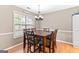Cozy dining room featuring a wood table with seating for six near a bright window at 372 River Point Dr, Mcdonough, GA 30252