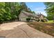 Long driveway leading to a charming ranch home with an attached garage at 372 River Point Dr, Mcdonough, GA 30252