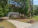 Long driveway leading to a ranch home with brick and vinyl siding at 372 River Point Dr, Mcdonough, GA 30252