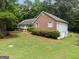 Charming home featuring brick accents, a well-manicured lawn, and lush landscaping that enhances its curb appeal at 372 River Point Dr, Mcdonough, GA 30252