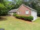 Ranch home showcasing brick and vinyl siding, complemented by lush greenery and well-maintained landscaping at 372 River Point Dr, Mcdonough, GA 30252