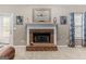 Inviting brick fireplace with a decorative mantle adds a cozy touch to this comfortable and stylish living space at 372 River Point Dr, Mcdonough, GA 30252