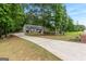 Charming home with a long driveway and large trees creating a peaceful setting at 372 River Point Dr, Mcdonough, GA 30252