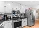 Stainless steel gas range and refrigerator in a bright and updated kitchen at 372 River Point Dr, Mcdonough, GA 30252