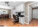 Eat-in kitchen with white cabinetry, stainless appliances, and built-in desk at 372 River Point Dr, Mcdonough, GA 30252