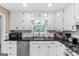 Updated kitchen featuring white cabinets, subway tile backsplash, and stainless steel appliances at 372 River Point Dr, Mcdonough, GA 30252