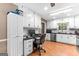 Eat-in kitchen with white cabinetry, stainless appliances, and built-in desk at 372 River Point Dr, Mcdonough, GA 30252