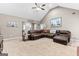 Spacious living room features a vaulted ceiling, comfortable leather seating, and abundant natural light at 372 River Point Dr, Mcdonough, GA 30252