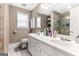 This main bathroom features a dual sink vanity, marble floors, and a large window at 372 River Point Dr, Mcdonough, GA 30252