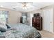 Comfortable bedroom with carpeted floors, ceiling fan, window with privacy curtains and dresser at 372 River Point Dr, Mcdonough, GA 30252