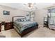 Comfortable main bedroom with a ceiling fan, neutral walls, and patterned bedspread at 372 River Point Dr, Mcdonough, GA 30252