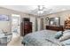 Comfortable main bedroom featuring neutral walls, a ceiling fan, and access to the en suite bathroom at 372 River Point Dr, Mcdonough, GA 30252