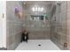 The recently renovated shower features mosaic tile, a rain shower head, and a built-in niche at 372 River Point Dr, Mcdonough, GA 30252