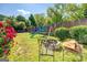 The backyard has a swing set, fire pit with chairs, a grass lawn, and is partially fenced in at 5327 David Se Cir, Covington, GA 30014