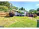 The backyard features a wood fence, small deck with stairs, and lush landscaping and green grass at 5327 David Se Cir, Covington, GA 30014