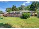 Expansive backyard with wooden deck, lush lawn, mature trees, and a swing set at 5327 David Se Cir, Covington, GA 30014