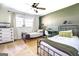 Bright bedroom with two twin beds, ceiling fan, natural light, and neutral carpeting at 5327 David Se Cir, Covington, GA 30014