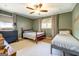 Cozy bedroom featuring plush carpet, ceiling fan and lots of natural light from large windows at 5327 David Se Cir, Covington, GA 30014