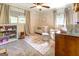 Charming Bedroom featuring a crib, comfortable rocking chair, a colorful rug, and bright windows at 5327 David Se Cir, Covington, GA 30014