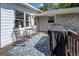 Back deck offers outdoor living space, wrought iron furniture, and a covered grill at 5327 David Se Cir, Covington, GA 30014