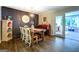 Dining room with hardwood floors, accent wall, wooden table, and view to sunroom at 5327 David Se Cir, Covington, GA 30014