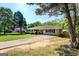 Charming single story home with a large front yard, mature trees and a long, concrete driveway at 5327 David Se Cir, Covington, GA 30014