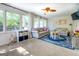 Bright living room featuring ceiling fan, recessed lights, and large windows at 5327 David Se Cir, Covington, GA 30014