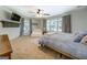 Bright main bedroom with plush carpet, ceiling fan and lots of natural light from large windows at 5327 David Se Cir, Covington, GA 30014