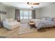 Bright main bedroom with plush carpet, ceiling fan and lots of natural light from large windows at 5327 David Se Cir, Covington, GA 30014