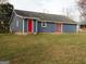 Exterior elevation featuring red doors, siding, and a well-maintained lawn at 56-1 N East Main St, Hampton, GA 30228