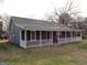 This single-story home boasts a covered front porch perfect for enjoying quiet moments outdoors at 56-1 N East Main St, Hampton, GA 30228