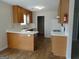 Functional kitchen with light wood cabinets, laminate countertops and wood-look flooring at 56-1 N East Main St, Hampton, GA 30228