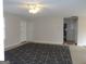 The spacious living room features neutral walls and carpet, with ample natural light at 56-1 N East Main St, Hampton, GA 30228