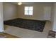 Bright and airy living room featuring neutral carpet and a large window at 56-1 N East Main St, Hampton, GA 30228