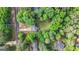 Aerial view showcasing the property's layout, driveway, and surrounding mature trees at 632 Cloudland Dr, Stockbridge, GA 30281