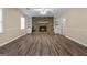 Basement living room features a cozy stone fireplace, neutral walls, and sleek hardwood floors at 632 Cloudland Dr, Stockbridge, GA 30281