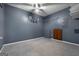 This basement has grey walls, carpet, and a ceiling fan at 632 Cloudland Dr, Stockbridge, GA 30281