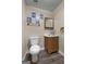 This bathroom has a toilet, vanity, mirror, and wood flooring at 632 Cloudland Dr, Stockbridge, GA 30281