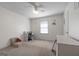 A bright bedroom featuring carpet, a ceiling fan, and a window for natural light at 632 Cloudland Dr, Stockbridge, GA 30281