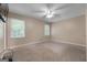 The bedroom has two windows, carpet, and a ceiling fan at 632 Cloudland Dr, Stockbridge, GA 30281