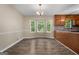 Bright dining room features hardwood floors, a stylish chandelier and a large bay window at 632 Cloudland Dr, Stockbridge, GA 30281