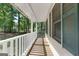 Long, covered front porch offers a relaxing space to enjoy the view at 632 Cloudland Dr, Stockbridge, GA 30281