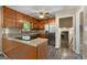 Kitchen with stainless appliances, wooden cabinets and hardwood floors. View to basement stairs at 632 Cloudland Dr, Stockbridge, GA 30281